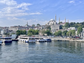 A scenic shot of Dubai's waterfront with boats and the city skyline in the background.