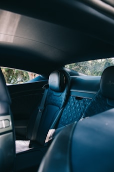 the interior of a car with blue leather seats