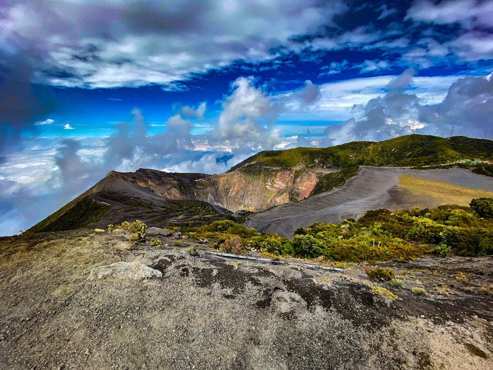 a view of a mountain range with clouds in the sky