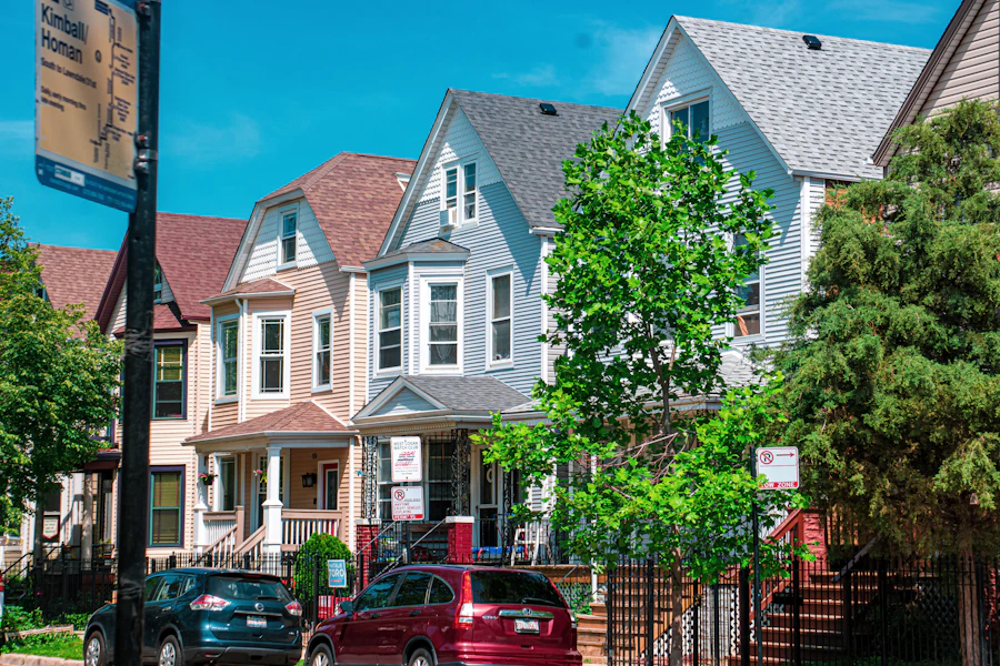 Row of Chicago brick houses with cars parked along a residential street