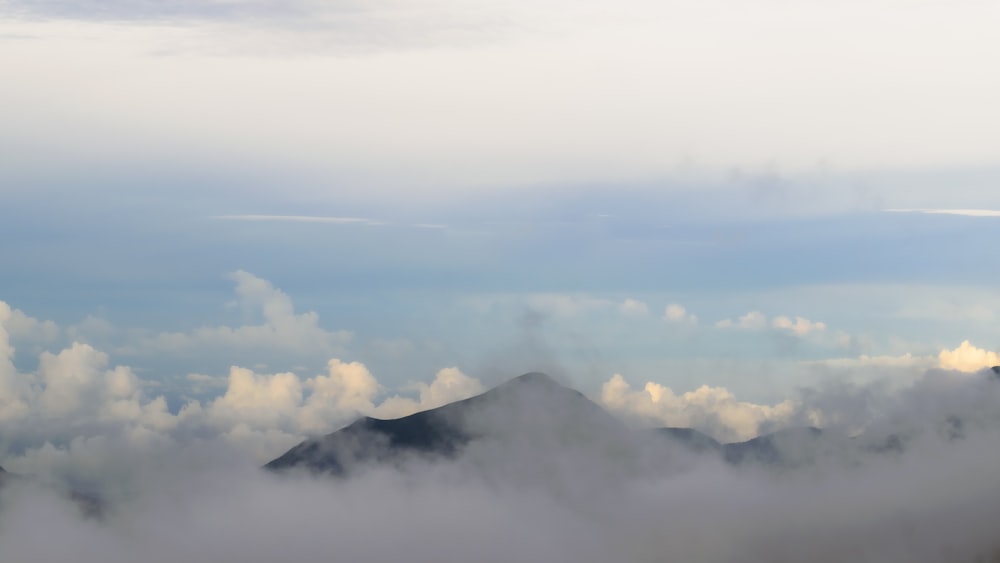 a view of clouds and mountains from an airplane