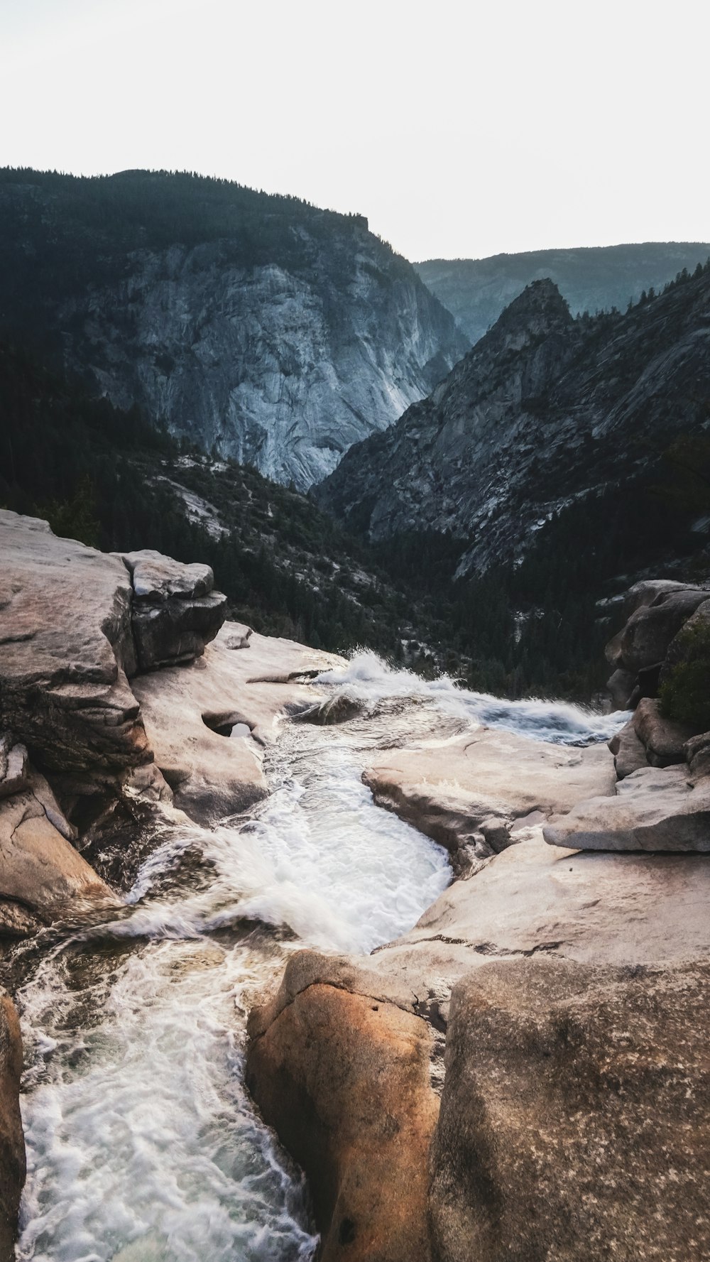 a river running through a valley surrounded by mountains