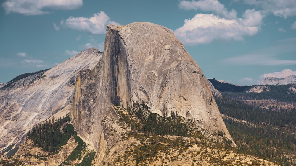 a large mountain with a very tall rock on top of it