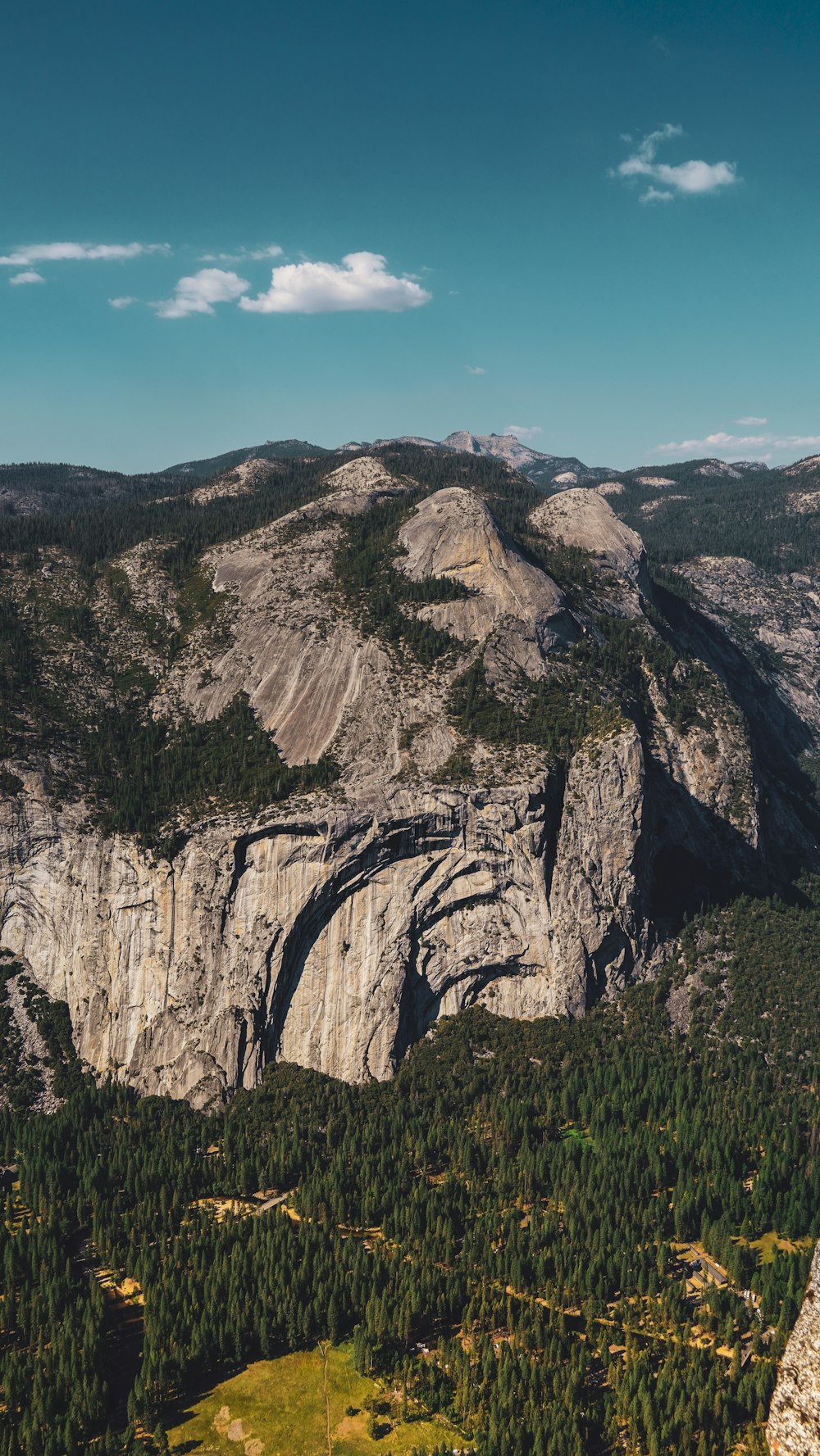 a view of a mountain with a forest below