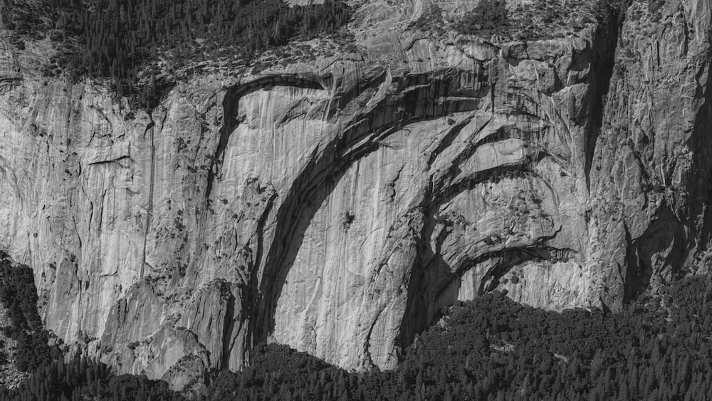 a black and white photo of a mountain side