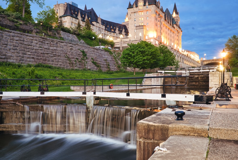 a large building with a waterfall in front of it