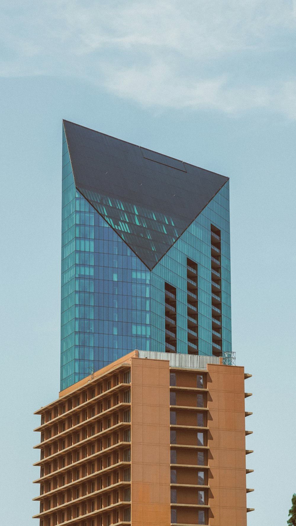 a tall building with a triangular shaped roof