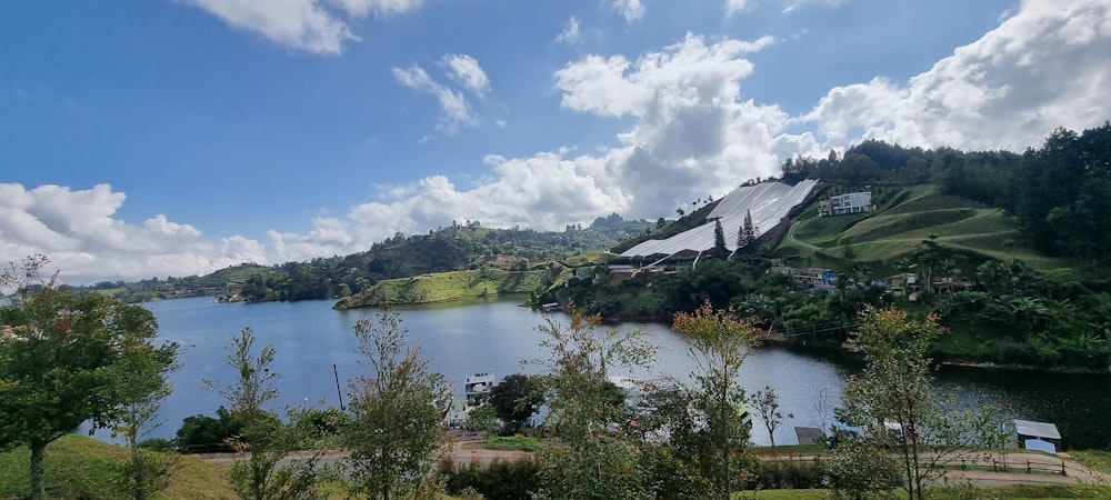 a large body of water surrounded by a lush green hillside