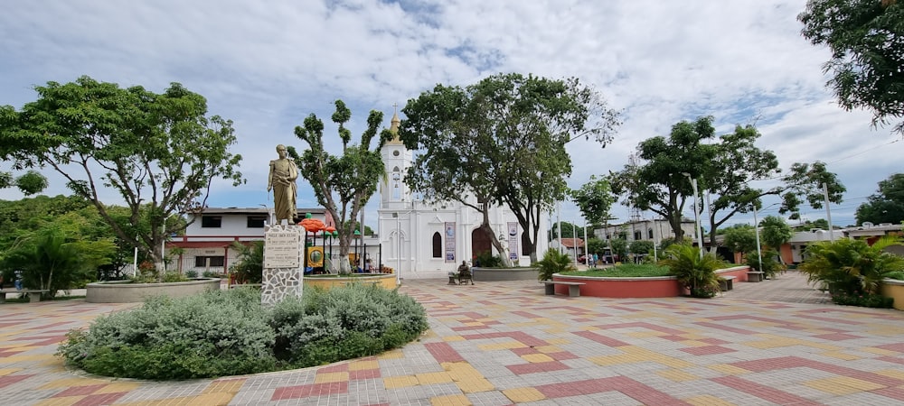 a large white building with a statue in the middle of it