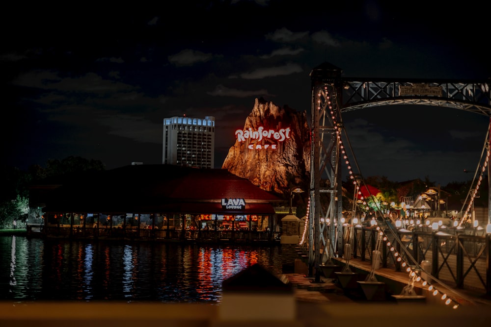 a bridge that has lights on it and a mountain in the background