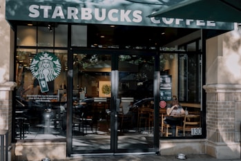 a starbucks coffee shop with a person sitting at a table
