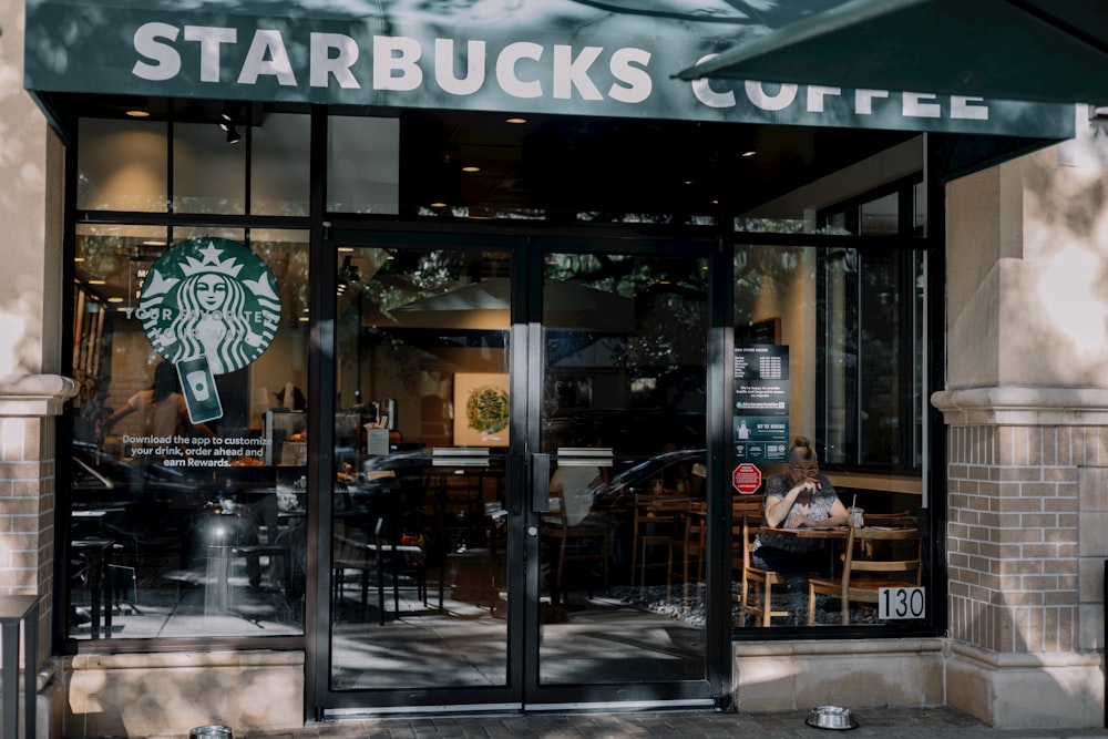 a starbucks coffee shop with a person sitting at a table