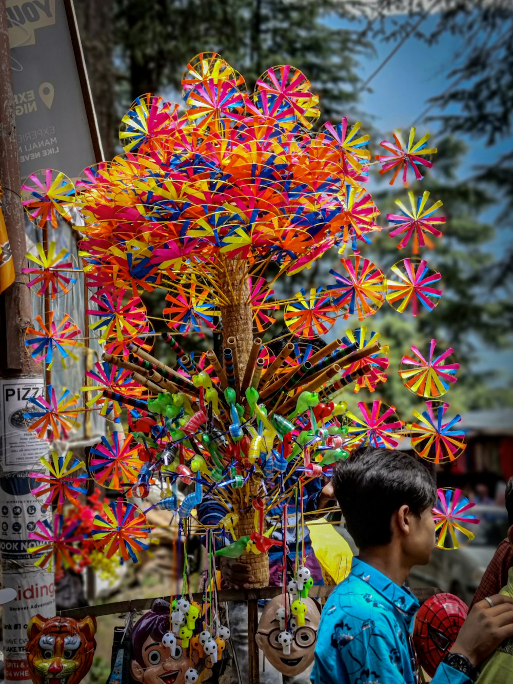 a man standing next to a colorful display of pinwheels