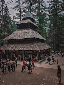 a group of people standing around a wooden structure