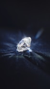 A certified diamond grading report alongside a brilliant cut diamond.