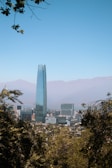 a view of a city with tall buildings and mountains in the background