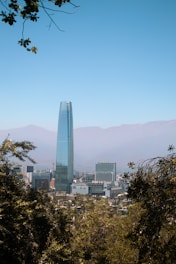 a view of a city with tall buildings and mountains in the background