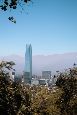 a view of a city with tall buildings and mountains in the background