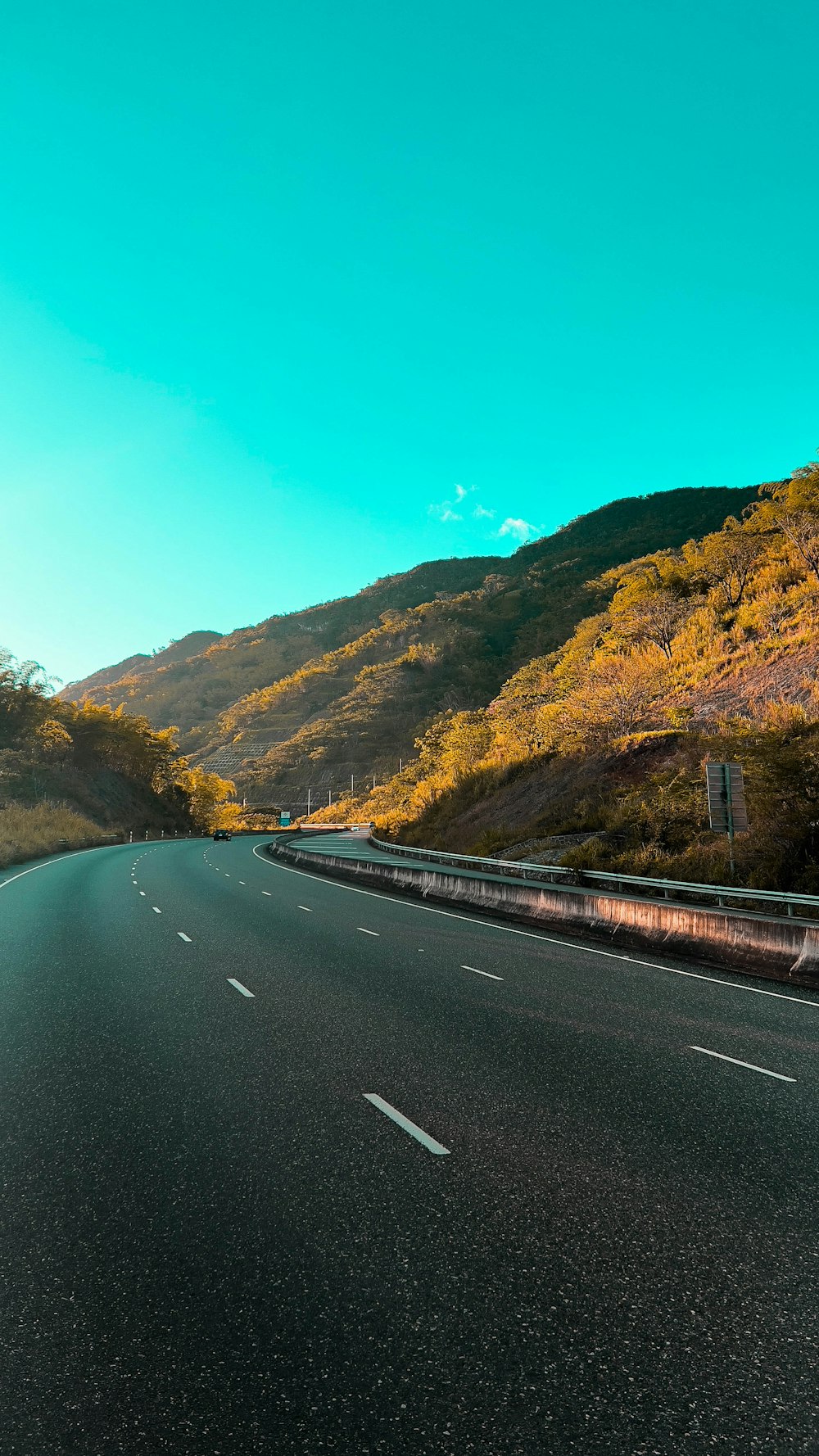 a long road with a mountain in the background