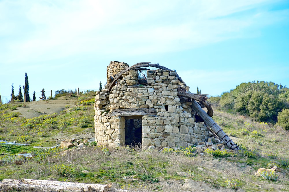 an old stone building sitting on top of a hill
