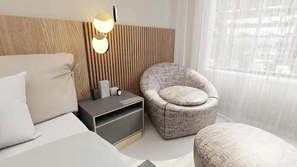 a bed room with a neatly made bed and a chair