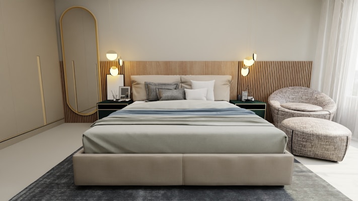 A modern bedroom with a large bed featuring neutral-colored bedding. The headboard has a textured wood design, and there are two round wall lamps on each side. A sleek, dark green nightstand holds a small framed picture and a book. To the right, there is a cozy round chair with a matching ottoman on a textured area rug. A full-length mirror stands against the wall near a wardrobe. Soft, natural light filters through sheer curtains.