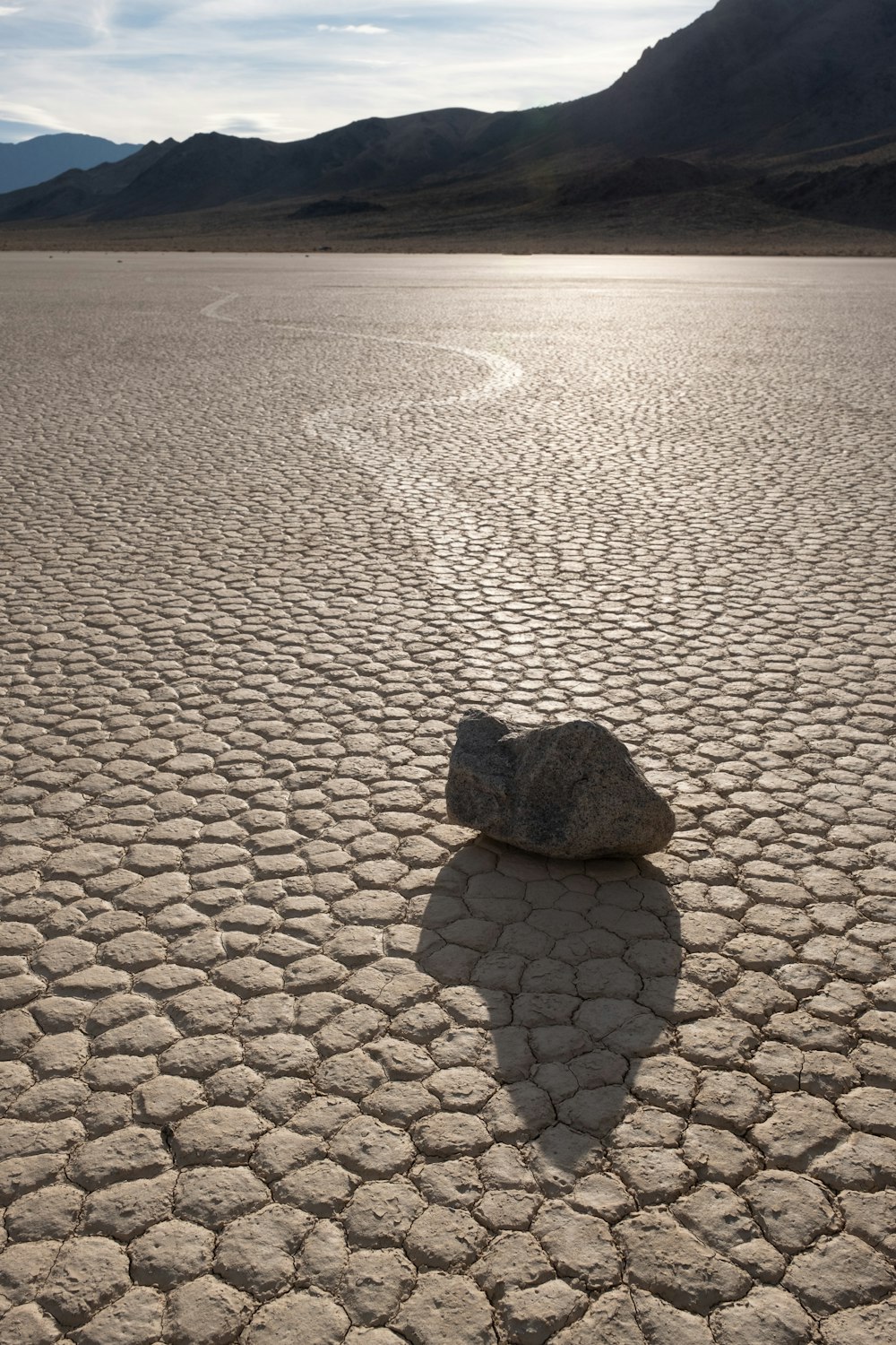 a rock sitting in the middle of a desert