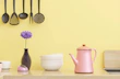 A colorful kitchen scene with a recipe book and fresh ingredients