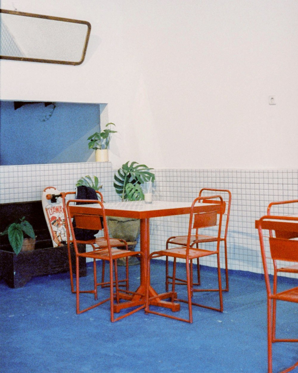a table and chairs in a room with a blue floor