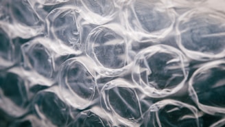Close-up view of transparent bubble wrap with a focus on the texture and patterns of the air-filled pockets.