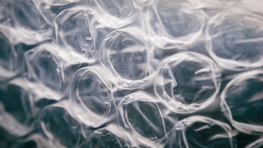 Close-up view of transparent bubble wrap with a focus on the texture and patterns of the air-filled pockets.