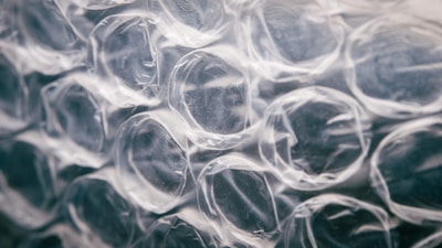 Close-up view of transparent bubble wrap with a focus on the texture and patterns of the air-filled pockets.