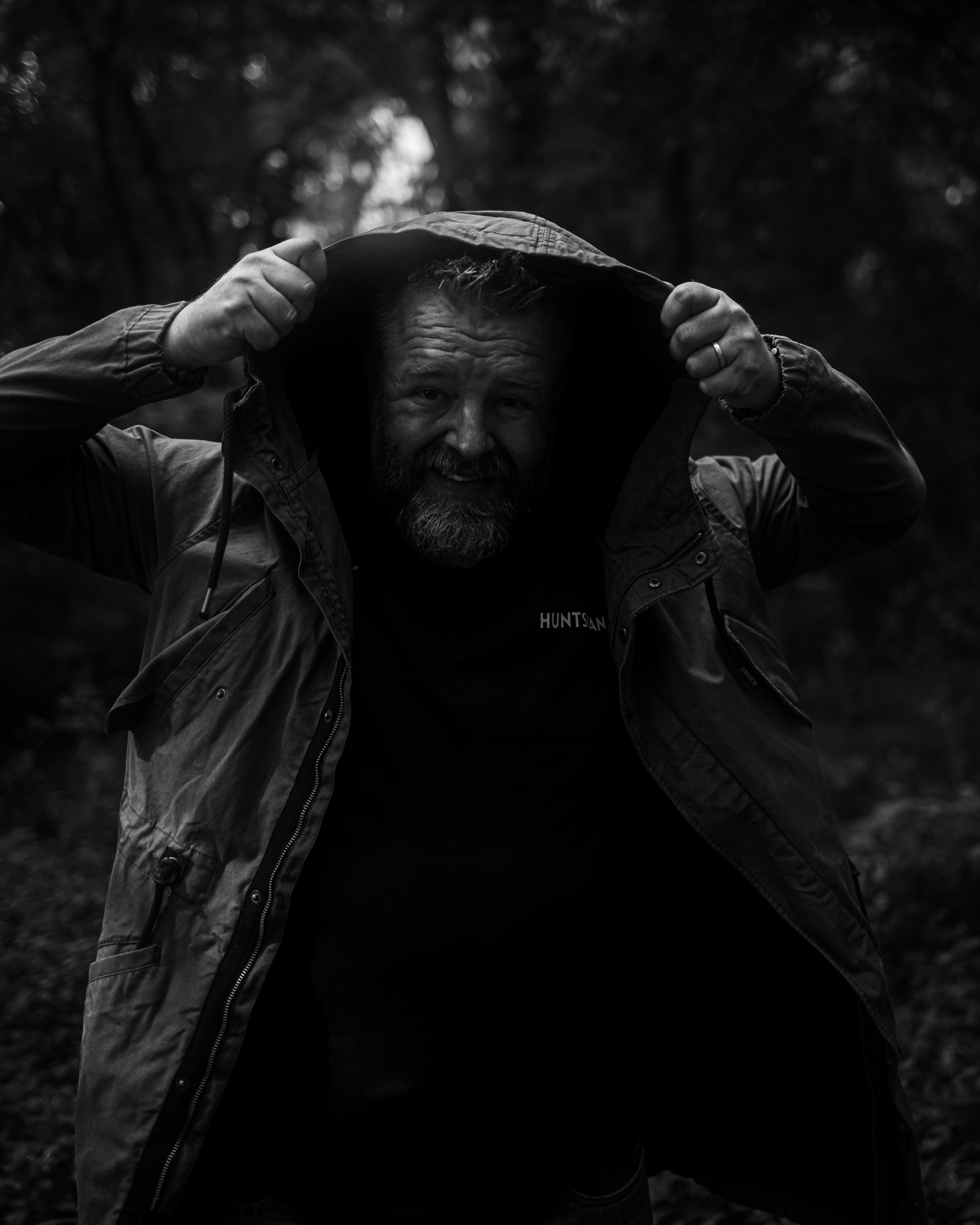 a man with a beard and a hooded jacket