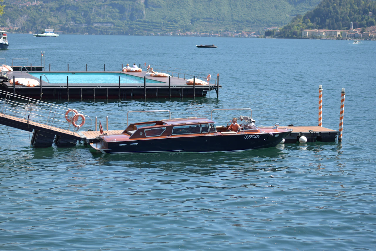 A single boat moored at a wooden pier
