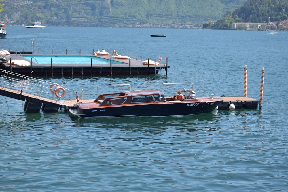 a boat is docked at a pier on a lake