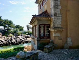 Stonework details blending seamlessly with green roofs and coastal surroundings.