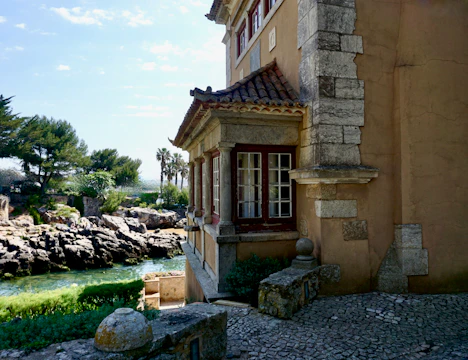 Stonework details blending seamlessly with green roofs and coastal surroundings.