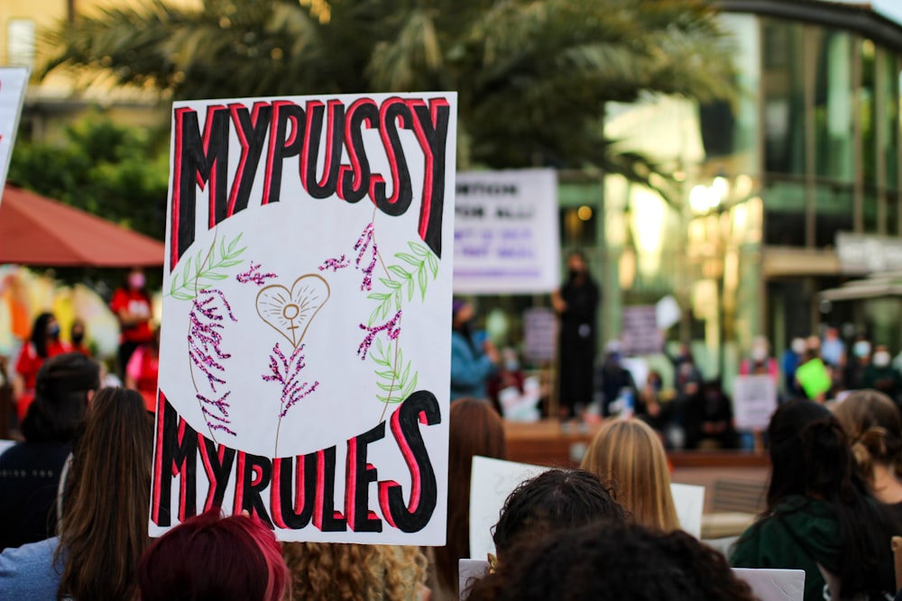 a group of people holding a sign that says myprousst my troubles