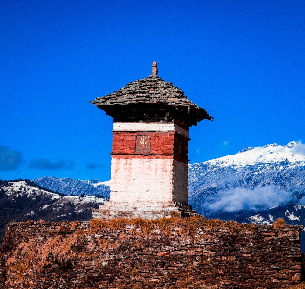 a tall brick tower sitting on top of a mountain