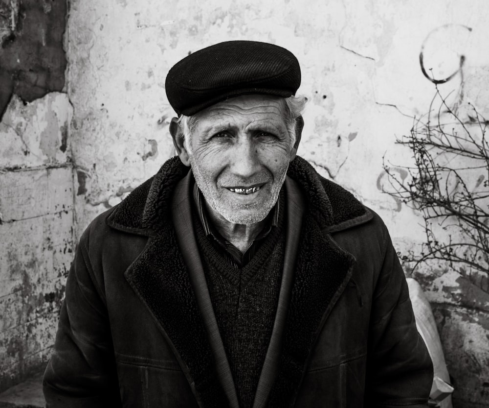 a black and white photo of a man wearing a hat