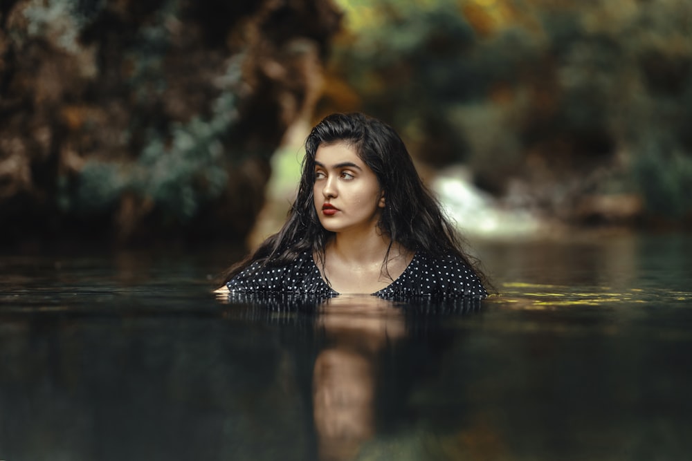 a woman is floating in a body of water