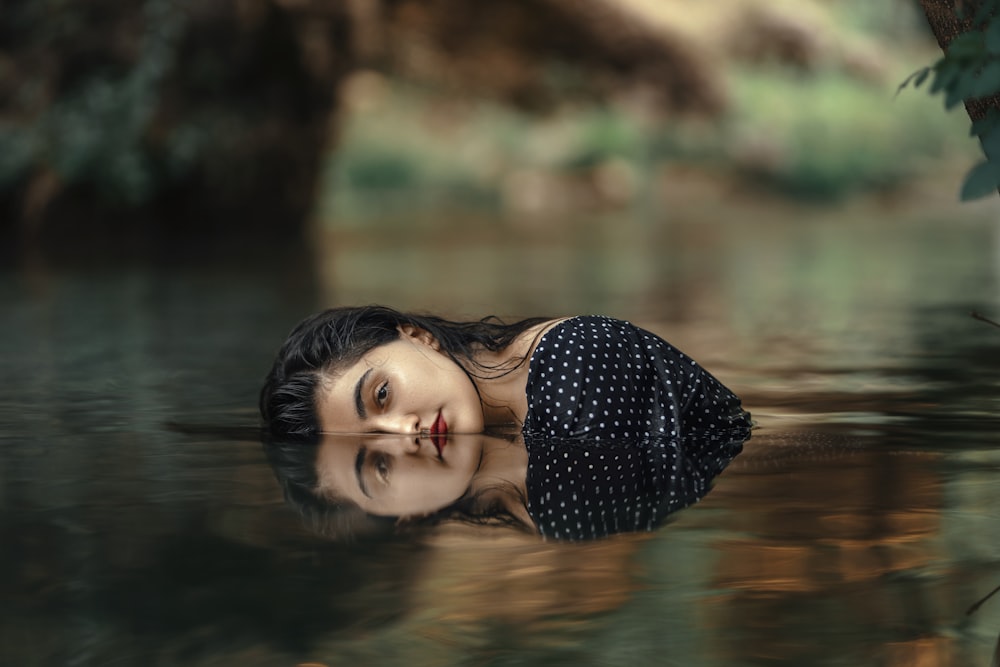 a woman is floating in a body of water