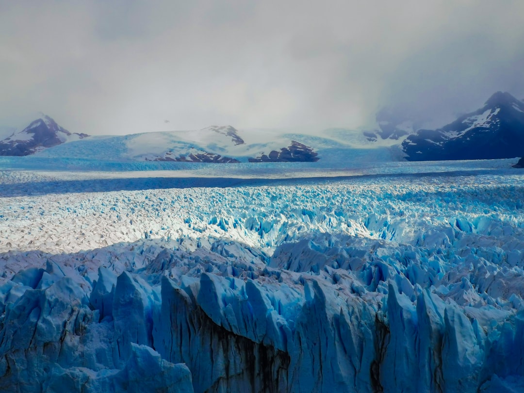 a large glacier with mountains in the background, The Moreno Glacier in Argentiina