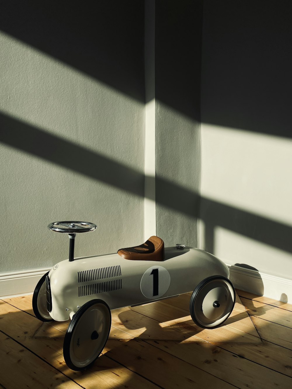 a toy car sitting on top of a wooden floor
