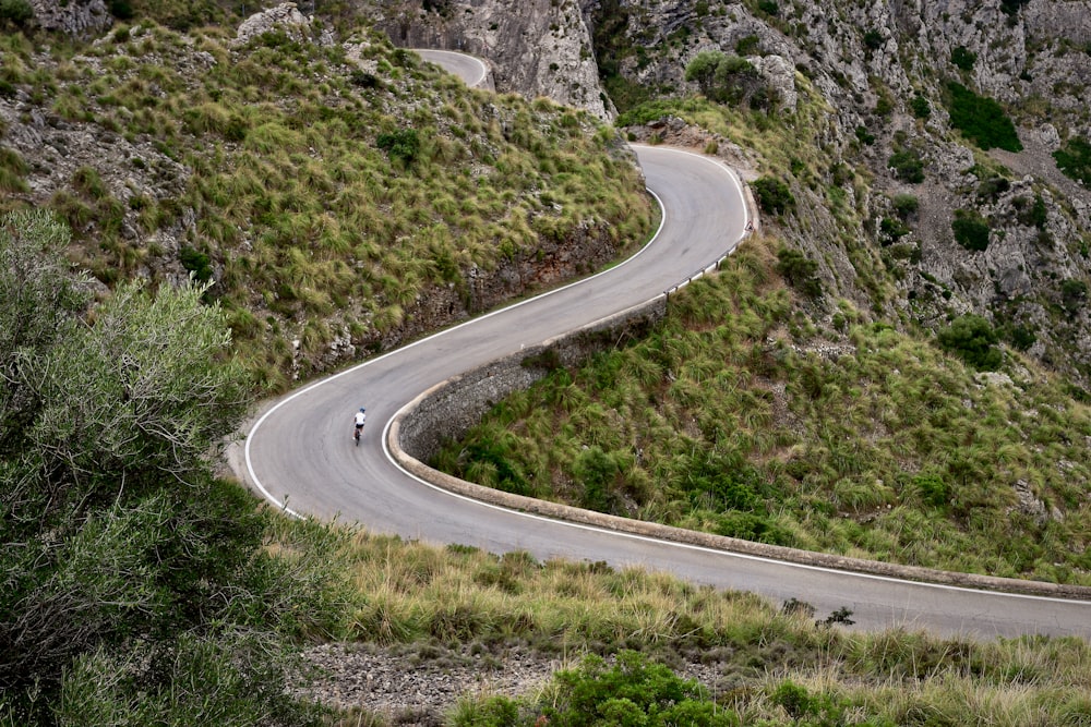 a person riding a motorcycle down a winding road