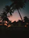 Cozy villa terrace overlooking palm trees with soft evening lighting.