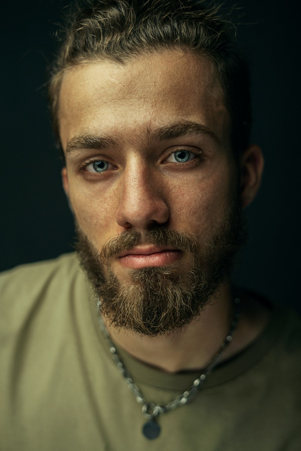 un homme avec une barbe et un collier