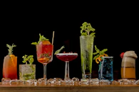 a table topped with lots of different types of drinks
