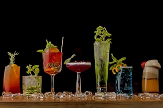 a table topped with lots of different types of drinks