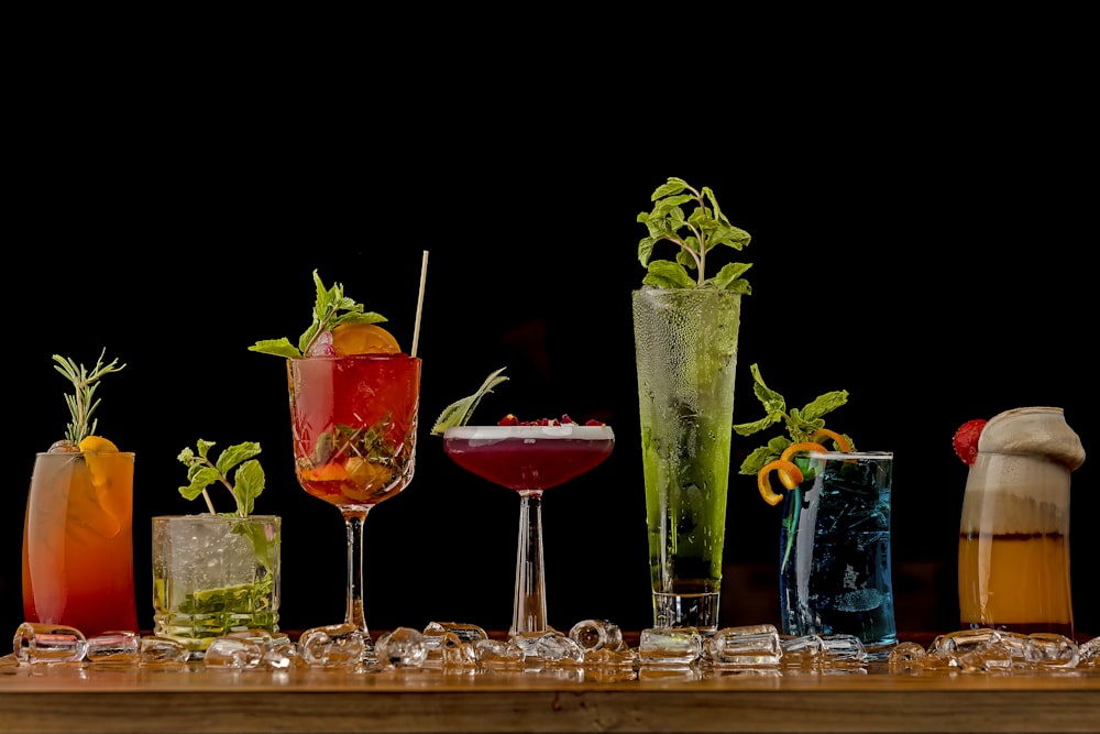 a table topped with lots of different types of drinks